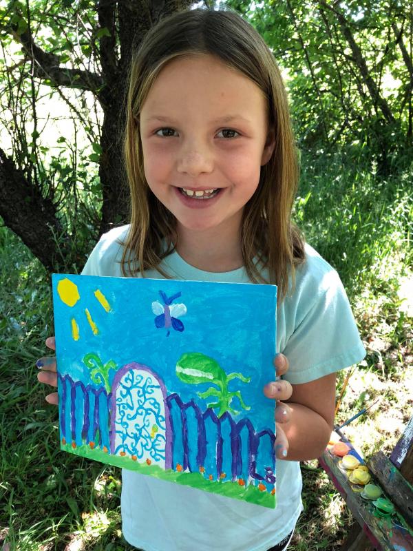 Child holding her watercolor - Artist in Residence